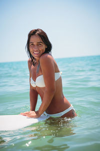 Young beautiful woman having fun swimming in the sea