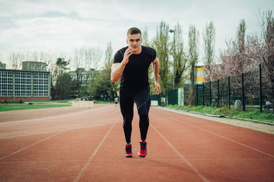 Full length of athlete running on track