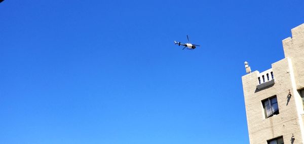 Low angle view of airplane flying in sky