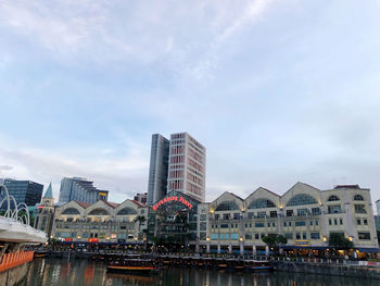 View of city buildings against cloudy sky