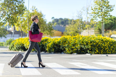 Full length of woman standing on road