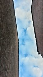 Low angle view of building against cloudy sky