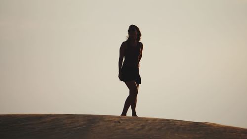 Full length of silhouette woman standing against clear sky