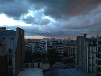 Buildings in city at sunset