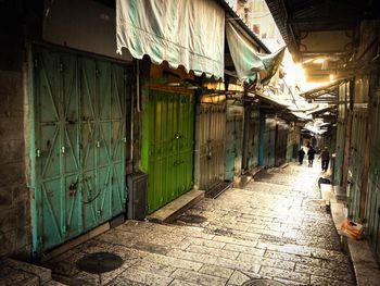 Empty alley amidst buildings in city