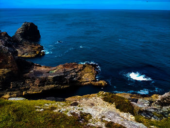 Scenic view of sea against rocks