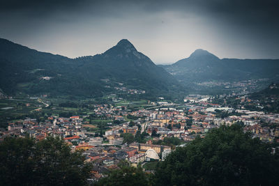 High angle view of townscape and mountains against sky