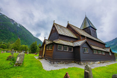 Traditional building on field against sky