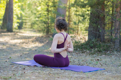 Side view of woman exercising in park