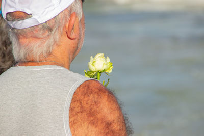 Rear view of man with flowers in water