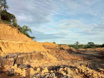 Rock formations on landscape against sky