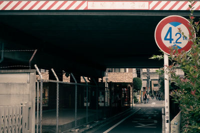 Road sign on bridge in city