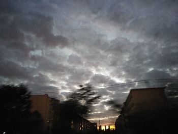 Low angle view of storm clouds over city