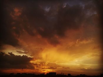 Low angle view of dramatic sky during sunset