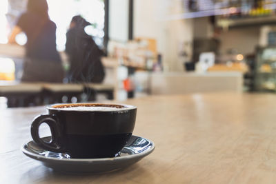 Coffee cup on table at cafe