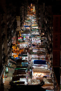 High angle view of illuminated city street and buildings at night