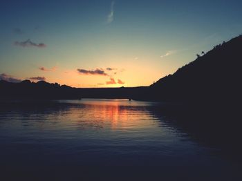 Scenic view of lake against romantic sky at sunset