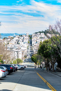 Street amidst buildings in city against sky