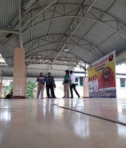 People walking on railroad station platform