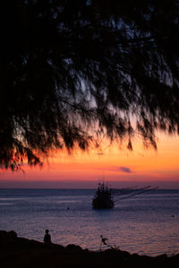 Silhouette sailboat on sea against sky during sunset
