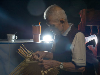 Side view of a man having food