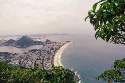 Scenic view of sea and mountains against sky