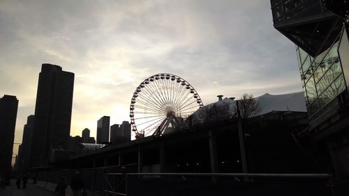 Low angle view of ferris wheel against sky