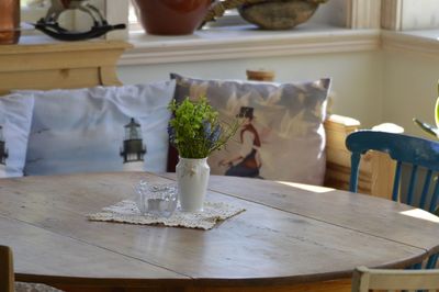 Close-up of vase and ashtray on table at home