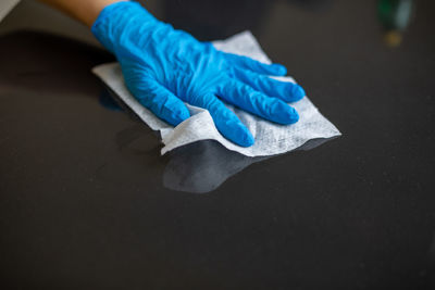 Close-up of hand holding blue umbrella