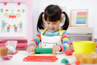 Young girl pretend  playing food preparing at home