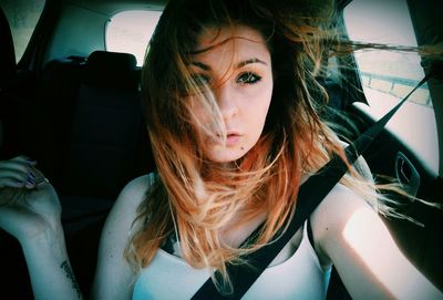 Portrait of young woman in car