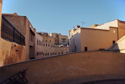 Residential buildings against clear blue sky