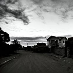 Empty road against cloudy sky
