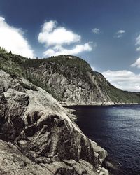 Scenic view of sea and mountains against sky