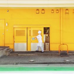 Man standing in yellow building