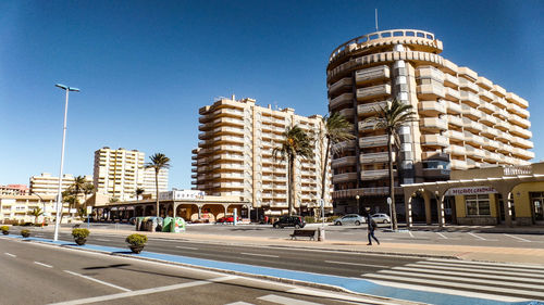 View of city street and buildings against sky