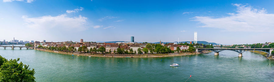 Bridge over river against buildings in city