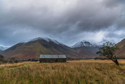 Scenic view of field and mountains against sky