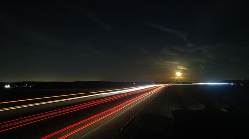 Light trails on road in city at night