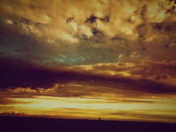 Scenic view of dramatic sky during sunset