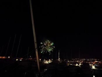 Illuminated cityscape against sky at night