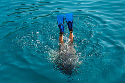 Low section of woman swimming in sea