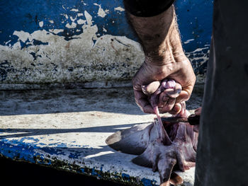 Low section of man holding water