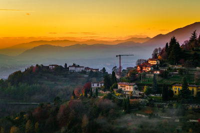 View of town against sky during sunset