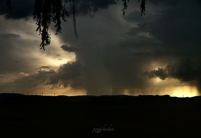 Silhouette of landscape against dramatic sky