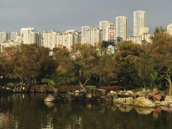 City by river against clear sky