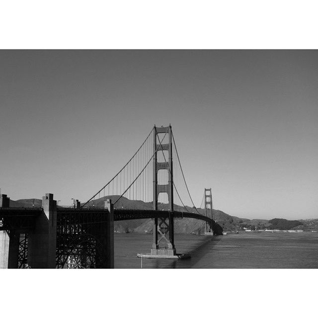 transfer print, built structure, architecture, connection, clear sky, auto post production filter, bridge - man made structure, water, copy space, bridge, river, engineering, suspension bridge, building exterior, sea, sky, waterfront, transportation, outdoors, no people