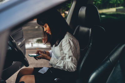 Man using mobile phone while sitting in car