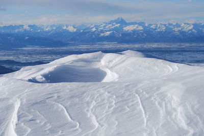 Scenic view of snow covered mountains against sky