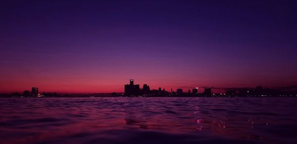 Silhouette buildings against sky at night